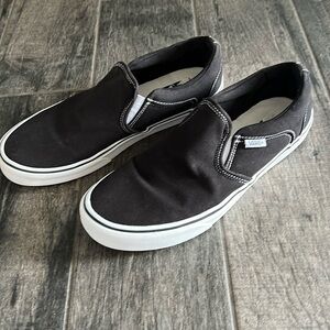 Black Vans Off the Wall slip-ons.